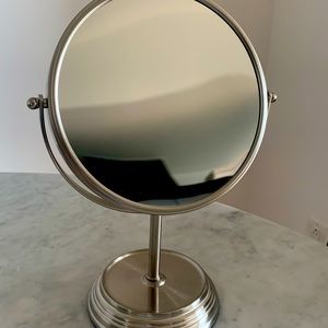 Makeup counter mirror in nickel finish